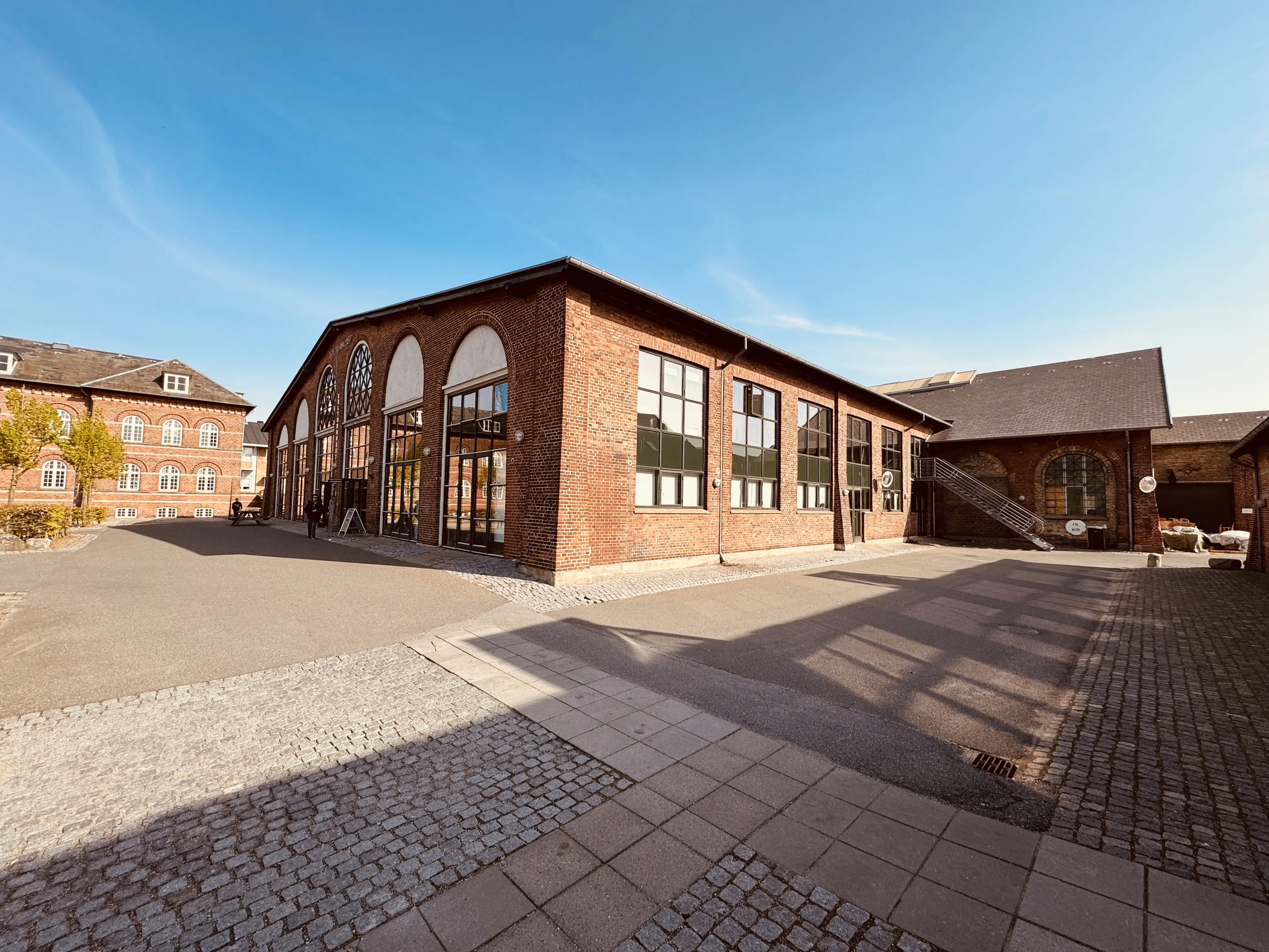 Billede af den nedlagte Triangel fabrik i Odense - her er det det tidligere værksted og monteringshal, hvor der har været en primitiv skydebro foran, da produktionen var i gang.